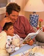 Εικόνα του πατέρα ακούει στο γιο του διαβάσετε ένα βιβλίο κατά την κατάκλιση